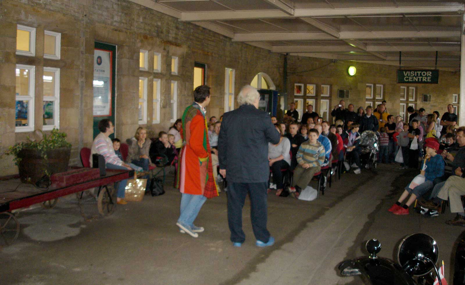 Colin regaling the audience, despite the occasional speeding train passing through the station