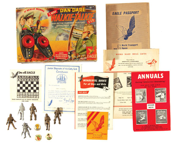 A lot that includes a Dan Dare Walkie-Talkie Set (early 1950s) produced by J & L Randall, unused in original box. Offered with a Jeff Arnold and two Dan Dare badges, an Eagle Passport with all four inserts, an Eagle Club Membership Card, an Eagle Pocket Chess and Draughts Set in card (no pieces) - plus three Eagle Annual and book flyers with Junior Shipmate of The Cutty Sark Eagle Certificate and six Dan Dare plastic figures
