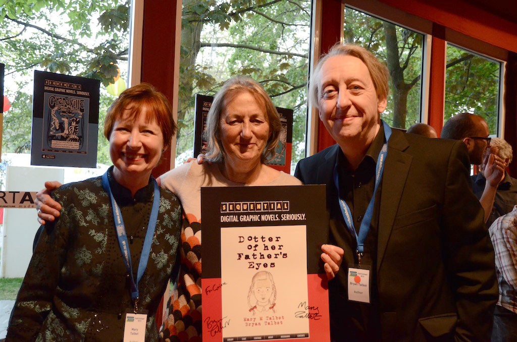 Mary Talbot (left) and Bryan Talbot (right) present a signed poster to Corinne Pearlman of Myriad Editions at the SEQUENTIAL party at the Edinburgh International Book Festival. Photo: Panel Nine