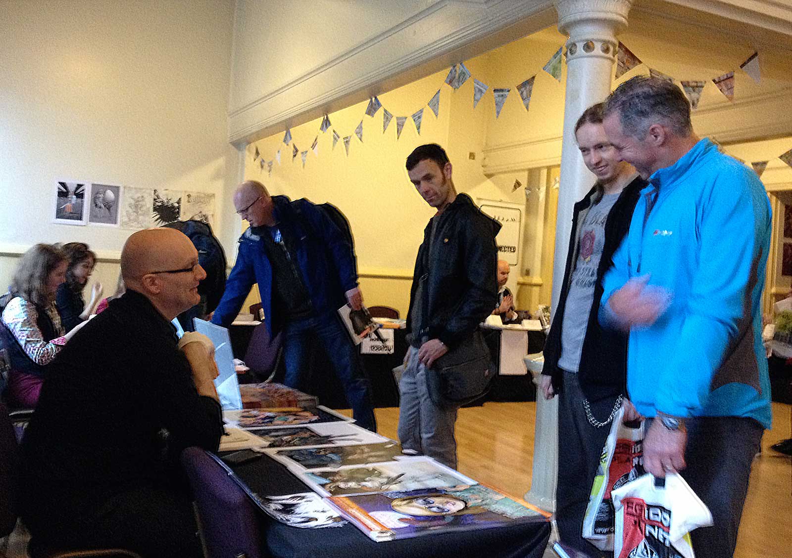 Artist Gary Erskine chatting with fans in the Clock Tower at last year's Lakes International Comic Art Festival. Far left: locally-based artist Kate Holden. In the background: artist Conor Boyle on the Disconnected Press stand