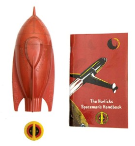 This Spaceship Cup and Cap Badge were originally offered in a promotion where you sent in sixpence or a shilling with a label from your Horlicks jar to get them. Between 1951-56 the beverage maker sponsored the Dan Dare Radio Show on Radio Luxembourg and young listeners were encouraged to enrol in the Horlicks Spacemans Club when they tuned in at 7.15, a mug of steaming Horlicks on the kitchen table, to hear Bob Danvers-Walker announce, ‘Dan Dare - Pilot Of The Future, brought to you by Horlicks – The food-drink of the night...’ Image: ComPal