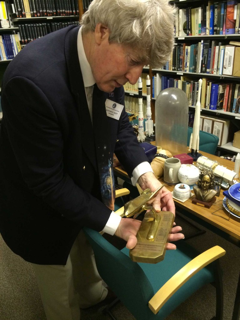 BIS President Alistair Scott shows off some of the Society's collection of space ephemera, held in its library.