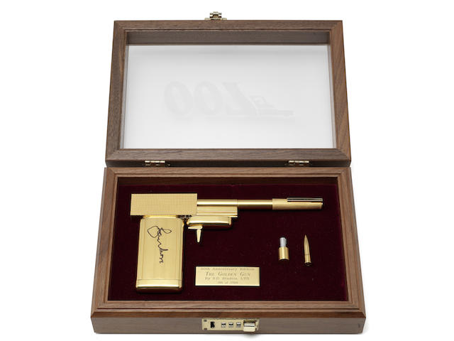 A replica gun from The Man with the Golden Gun, signed by Roger Moore.