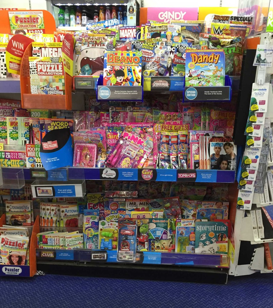 WH Smiths children's magazines rack, August 2015, which includes comics such as The Beano and both Panini's Doctor Who Adventures and Titan's Doctor Who Comic. As with some other Smiths stories (depending on their size) adventure comics aimed at older audiences such as 2000AD and Commando, and Panini's Marvel superhero titles, are racked in a separate section of this store.