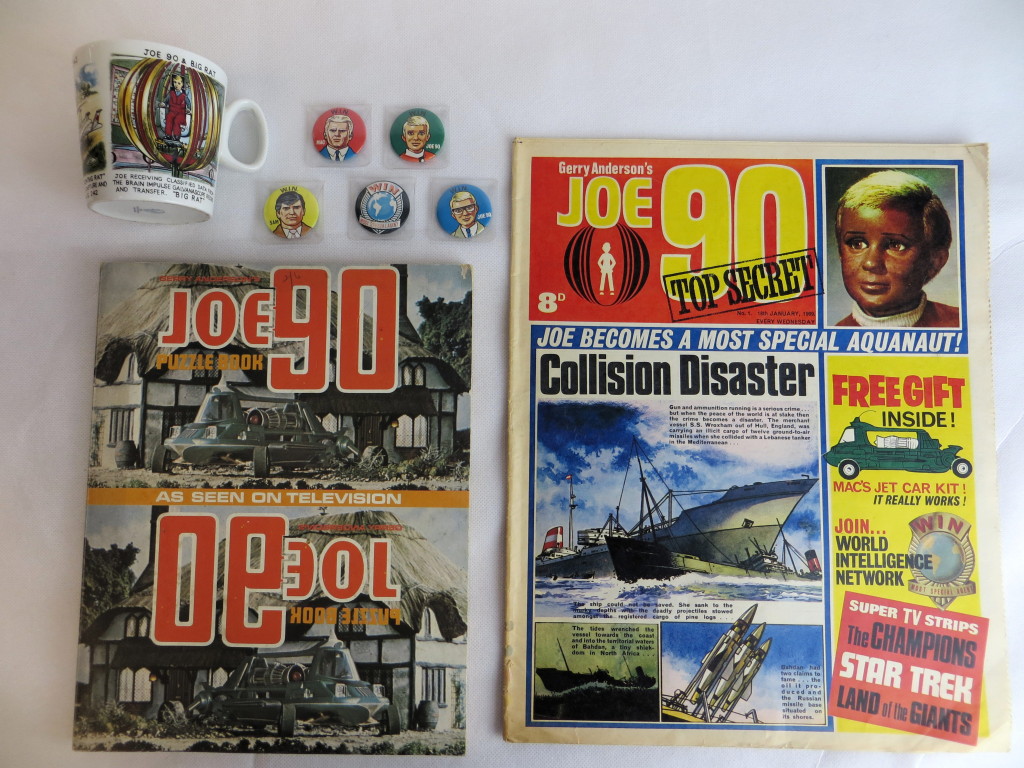 A Joe 90 Comic Number One, published in 1969, with Joe 90 puzzle book, Washington pottery mug and badges, being offered at auction in Cardiff today by Langley and Jones