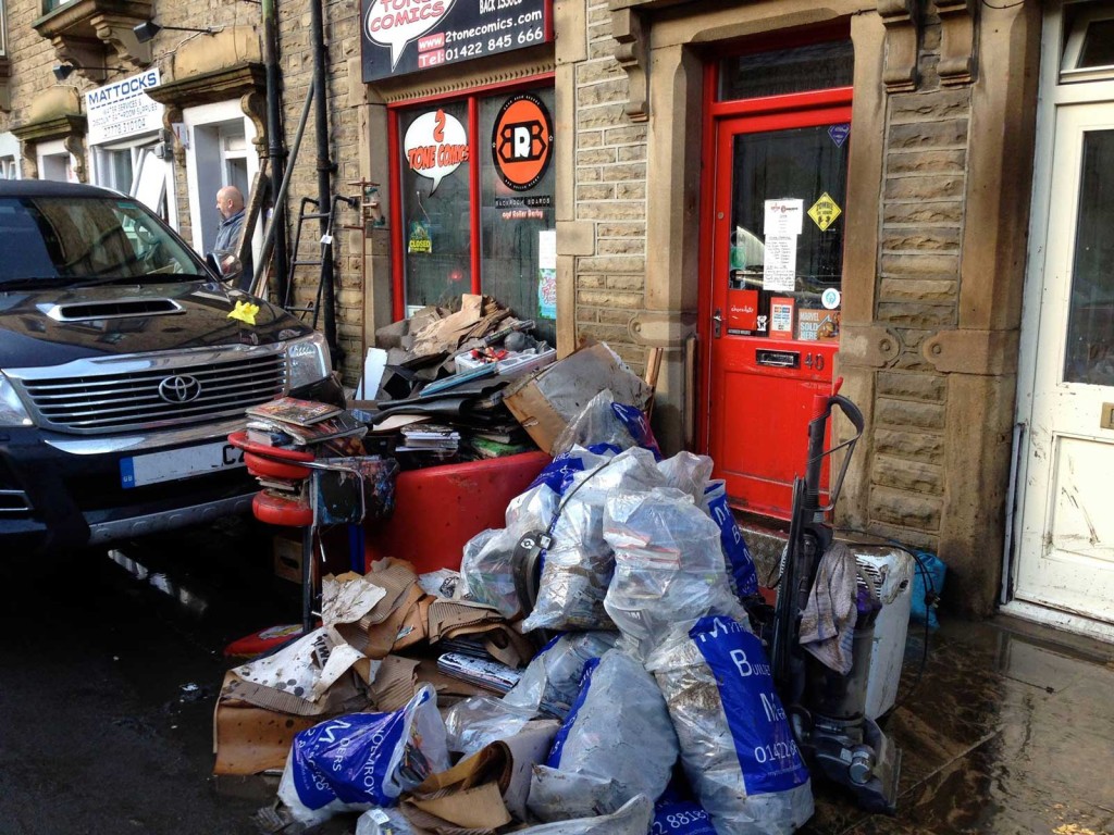 After the storm: clean up work begins at 2 Tone Comics, Hebden Bride. Fand and friends of the independent comic shop have rallied to help raise funds to get the owners, who were unable to insure the shop after previous flooding, back on its feet. Photo: 2 Tone Comics