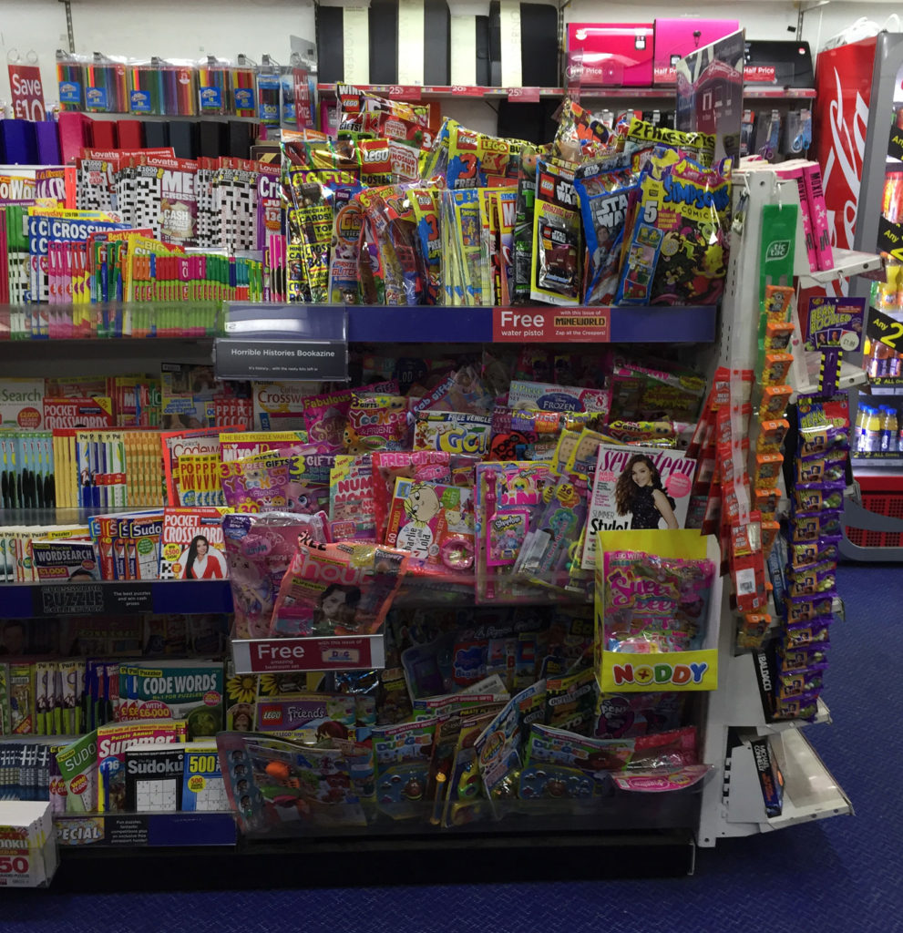 The children's magazine section of a typical mid-range WHSmith, July 2017. Because WHSmith have given over much shelf space to non-magazine items in this store the comics are cramped and many are at adult height, limiting purchase choice for younger buyers - a far cry from past decades when all comics were within easy reach in newsagents to encourage a pocket money spend.
