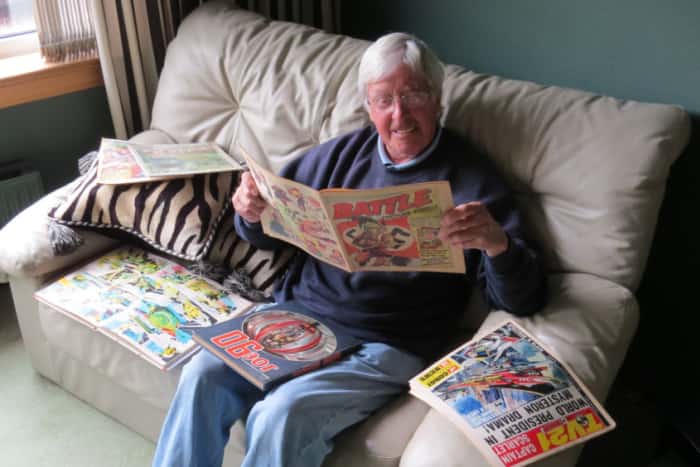 Comic artist Jim Watson, surrounded by some of the comics he worked on. Image: The Scotsman