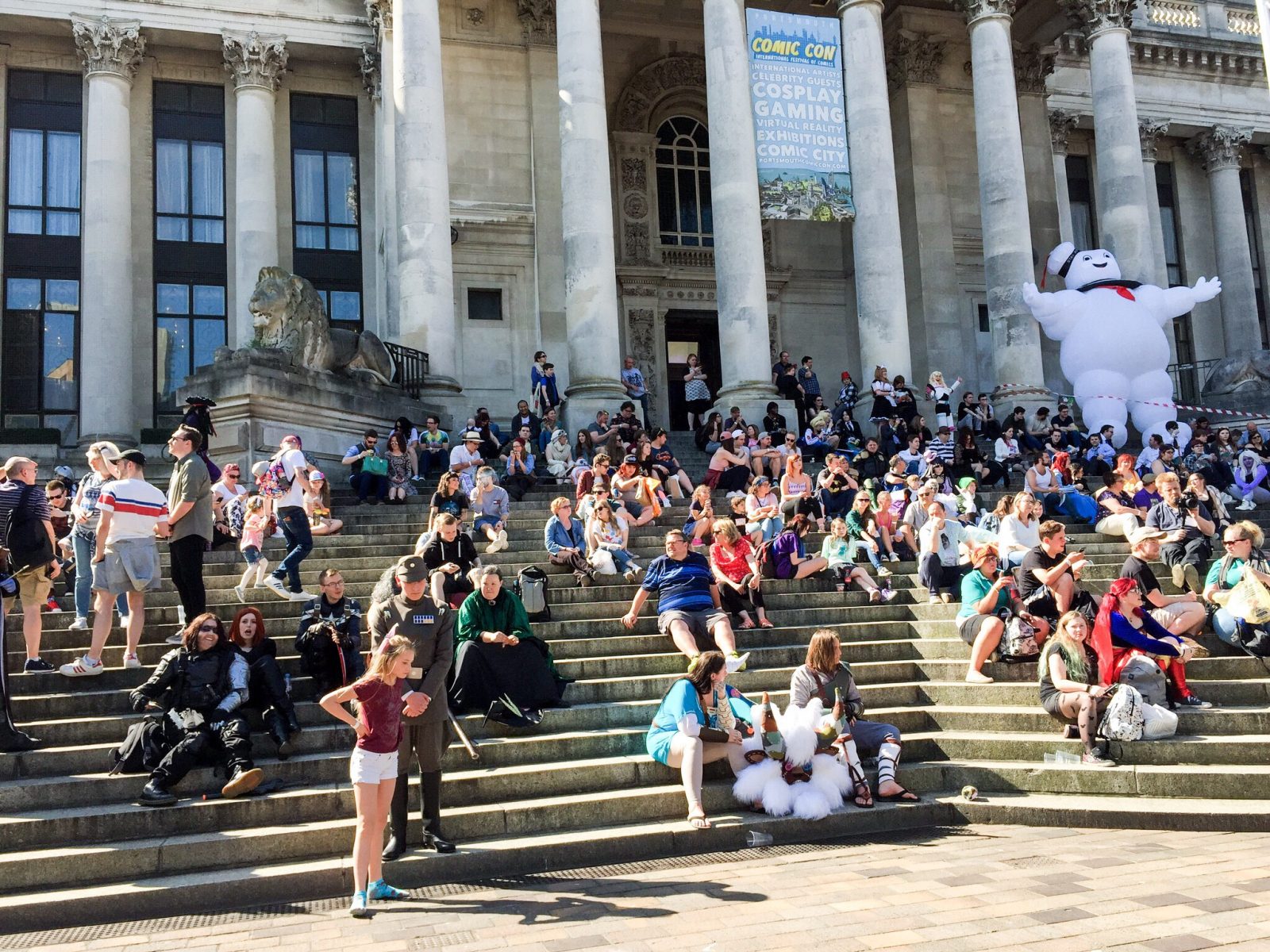 Enjoying the sun: Portsmouth Comic Con attendees on the steps of the Guildhall