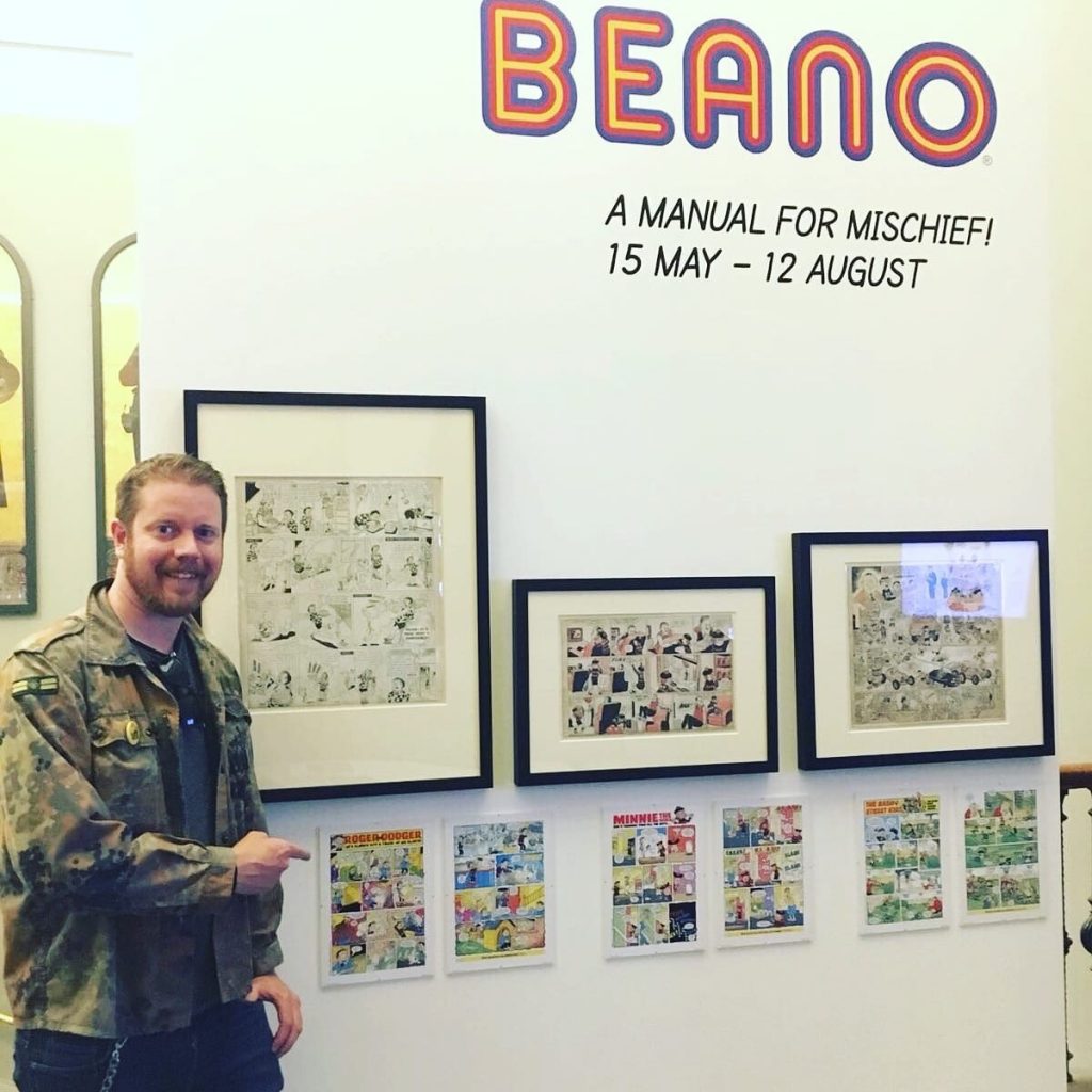 Comics writer and editor Danny Pearson discovers one of his “Roger the Dodger” strips, drawn by Barry Appleby, in the V&amp;A exhibition. Photo courtesy Danny Pearson