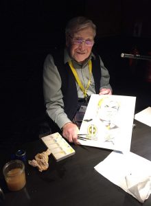 Ian Kennedy with the Dan Dare art he coloured on stage