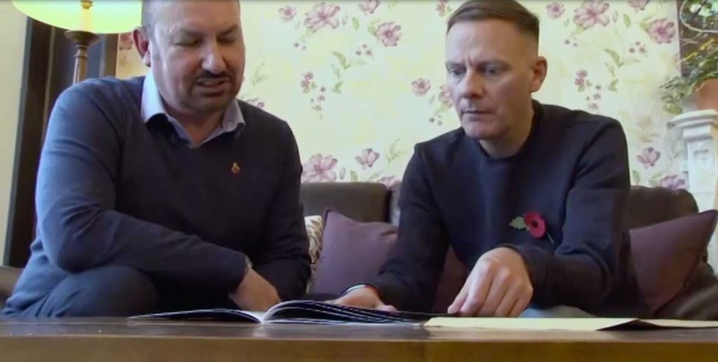 Actor Antony Cotton, ambassador for Armed Forces charities Help For Heroes and SSAFA, formerly known as Soldiers, Sailors, Airmen and Families Association, presents Philip Livingstone with a print edition of Fantastic Forces - The Longest Road. Image: Forces News