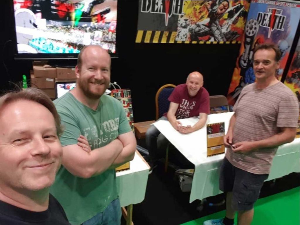 Dave and Adrian Clarke of GetMyComics with Simon Furman and Geoff Senior at MCM in 2019. Photo courtesy Adrian Clarke