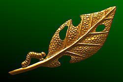 Caterpillar and Leaf Brooch designed by Tim White. An 18ct gold brooch, two inches in size, of a caterpillar nibbled leaf