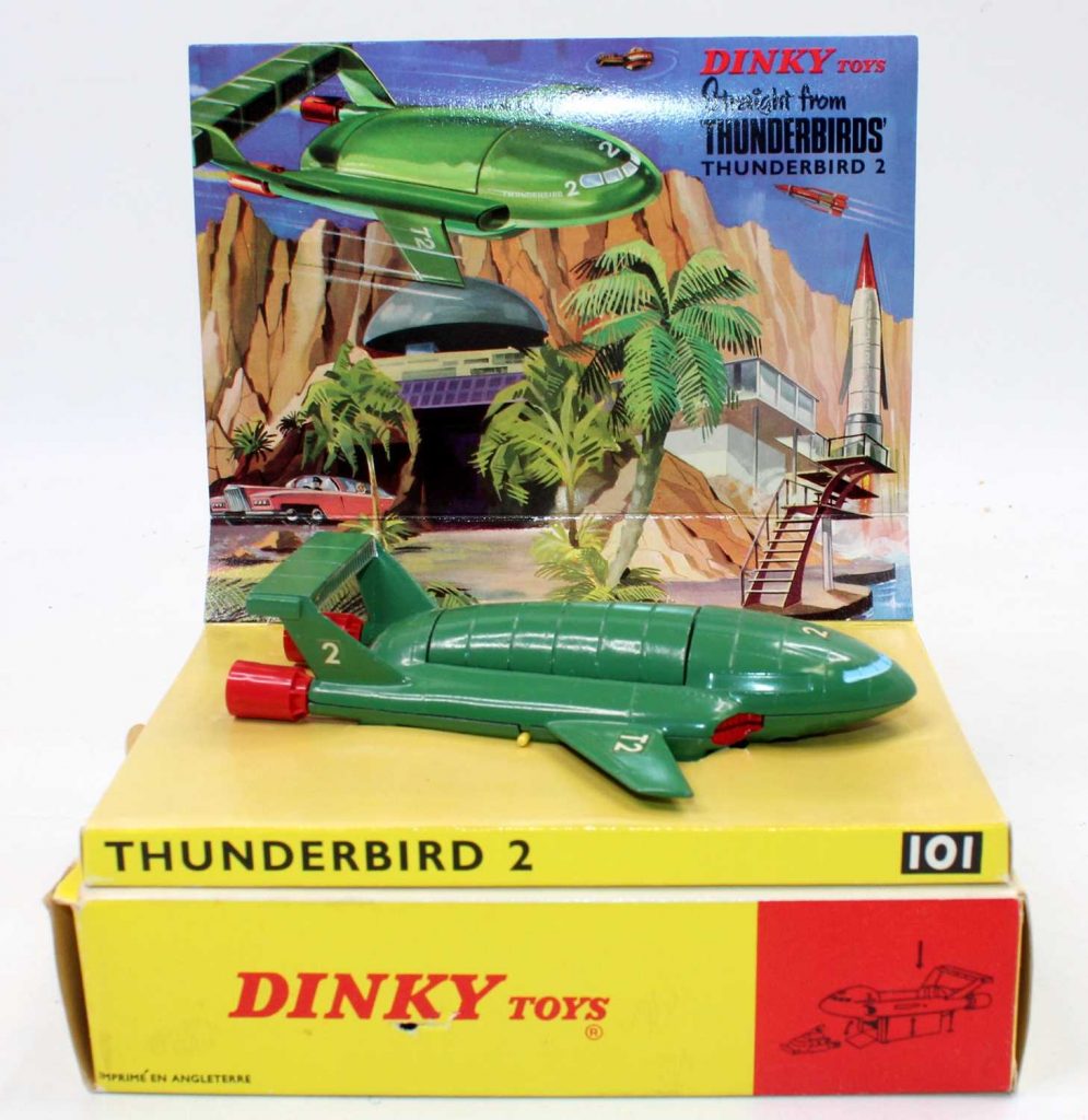 Dinky Toys No.101 Thunderbird 2, comprising of green body with four yellow plastic legs and red rear boosters, complete with capsule containing Thunderbird 4, housed in the original sliding tray box with packing piece and sliding card section