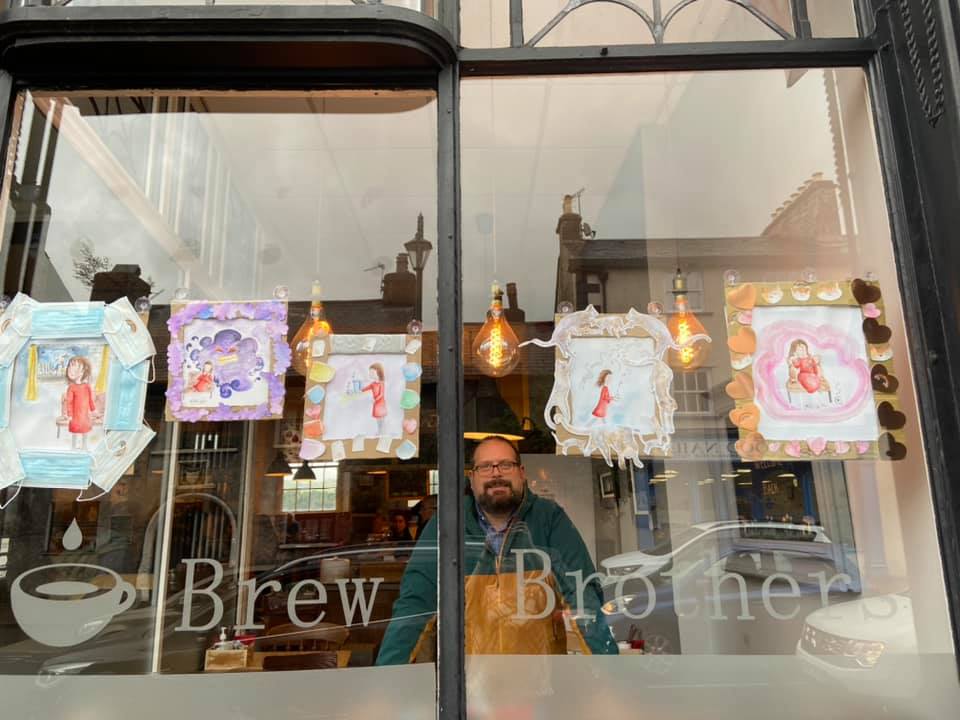 Festival podcast host Ian Loxam in Brew Brothers, Kendal and Nicole Bates' watercolour art honouring pets - just one of this year's Windows Trail displays