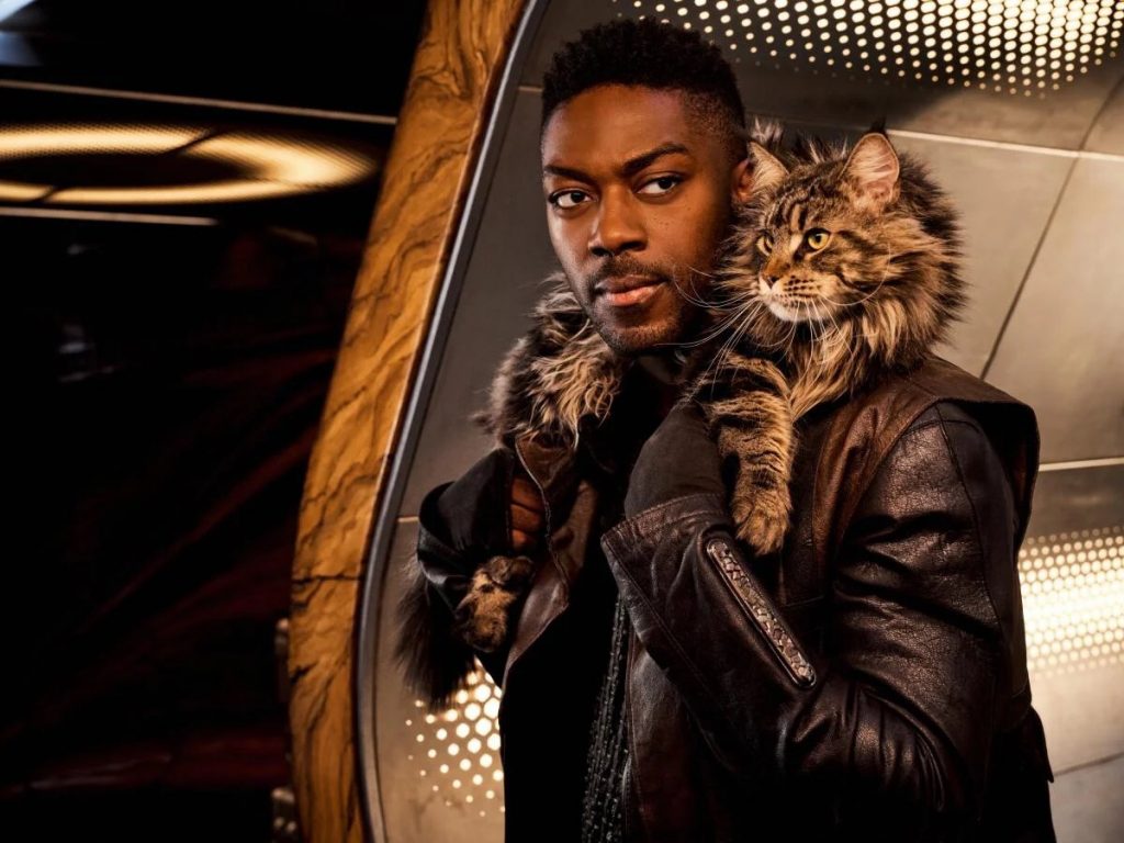 Cleveland "Book" Booker (David Ajala) with his feline Star Trek: Discovery co-star draped over his shoulders. Photo: James Dimmock/CBS