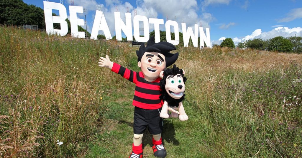 What’s as tall as a giraffe and three buses long?  The BEANOTOWN MEGA-SIGN! Dennis and Gnasher have been busy constructing this massive sign in Dundee to un-officially rebrand it as Beanotown. Image: BEANO
