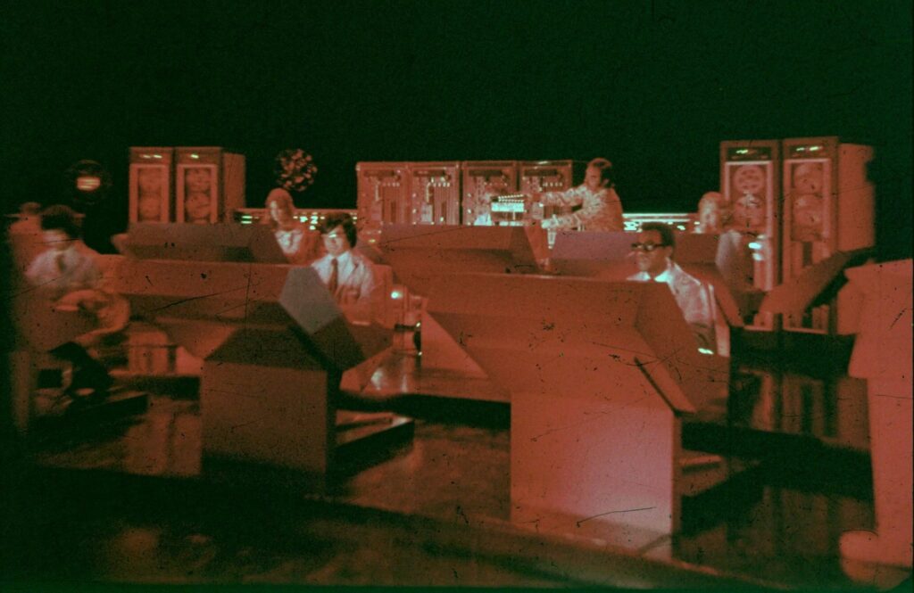 Another scene in Probe Control being slated for the Search episode "The Gold Machine." From left to right: Tony De Costa (Ramos), Amy Farrell (Murdoch), Byron Chung (Kuroda), Burgess Meredith (Cameron), an unidentified clapper boy, Albert Popwell (Griffin), and David Gilliam (Burrell). The filming date was approximately mid-June 1972 | Via SEARCH Facebook Page