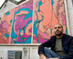 Mehdi Annassi alongside his Windermere Arctic Charr mural at the Lake District Boat Club for LICAF 2022