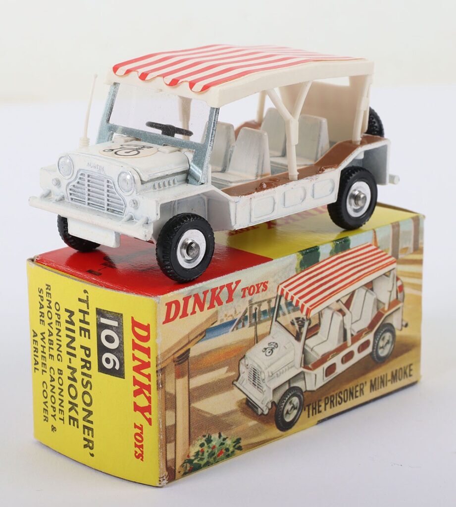 Dinky Toys 106 ‘The Prisoner’ Mini–Moke, white body, white and red canopy, aerial, Bicycle decal to bonnet, missing rear spare wheel cover, in near mint original condition, illustrated card box is in near mint original condition
