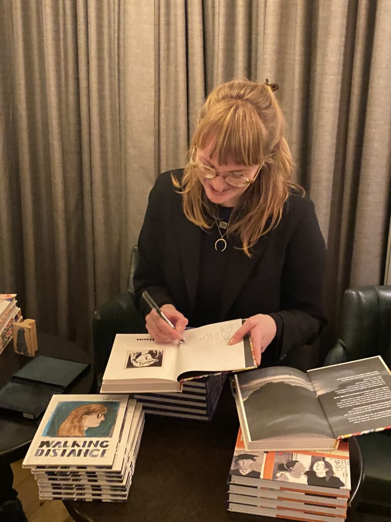 Lizzy Stewart signing books at Comica. Photo: Dean Simons