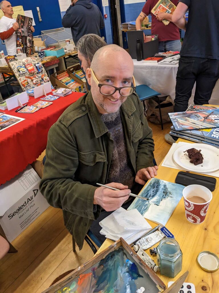 Commando and British Comics Swap Meet, 1st April 2023. Artist Keith Burns at work. Keith has been working on a series of 12 Ladybird books over the last five years plus with author James Holland. The collected edition, The Second World War: An Illustrated History is available to buy now.