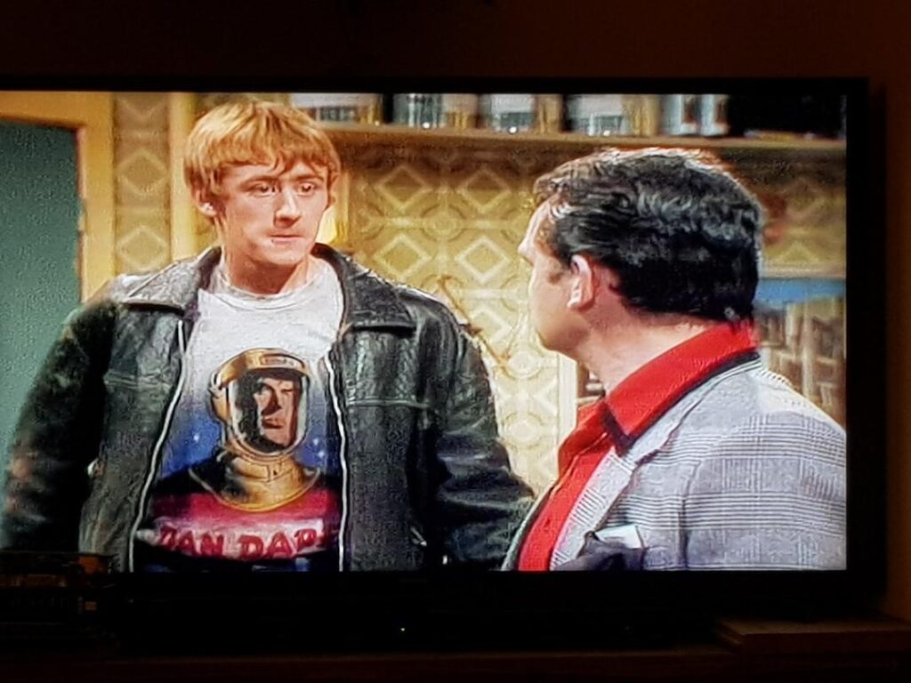 Nicholas Lyndhusrt as Rodney Trotter in the opening episode of Only Fools and Horses, sporting a Dan Dare t-shirt