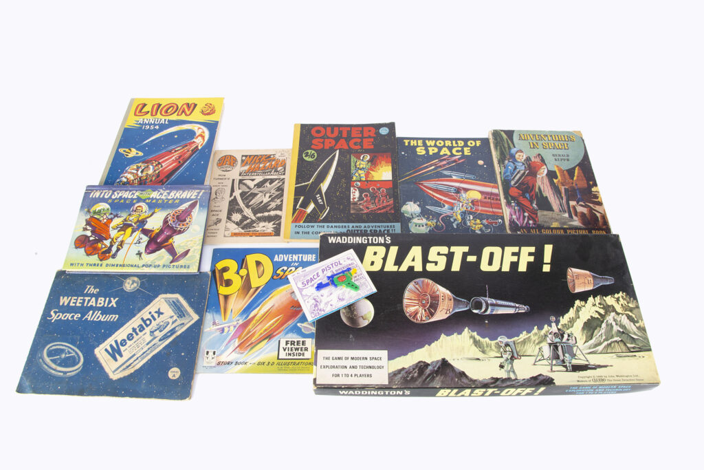 Space themed books, Birn Brothers Into Space with Ace Brave pop-up book, G.T. Ltd Outer Space comic, 1954-55 Lion Annuals, The Adventure of Captainn Space Kingley and others; and Waddington’s Blast-Off!