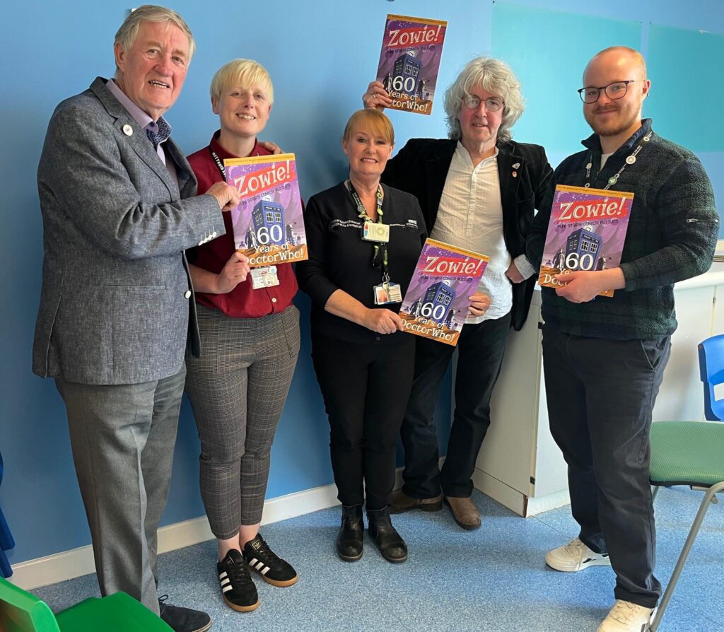 Liverpool Heartbeat originator Robin Baynes and Tim Quinn present Zowie!, a brand new comic book to the management team at the Royal Manchester Children's Hospital. Picture courtesy of Tim Quinn and used with permission