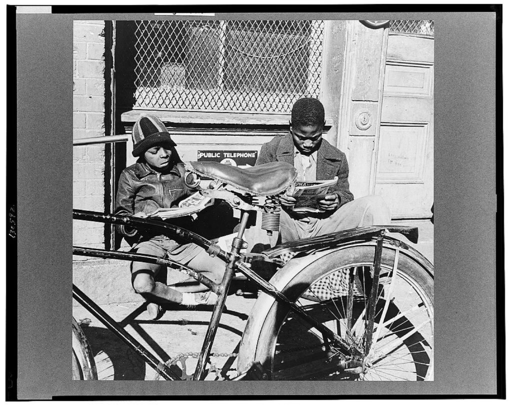Two boys reading the funnies on a doorstep. United States Washington D.C. District of Columbia Washington D.C, in November 1942. Photograph by Gordon Parks: Library of Congress