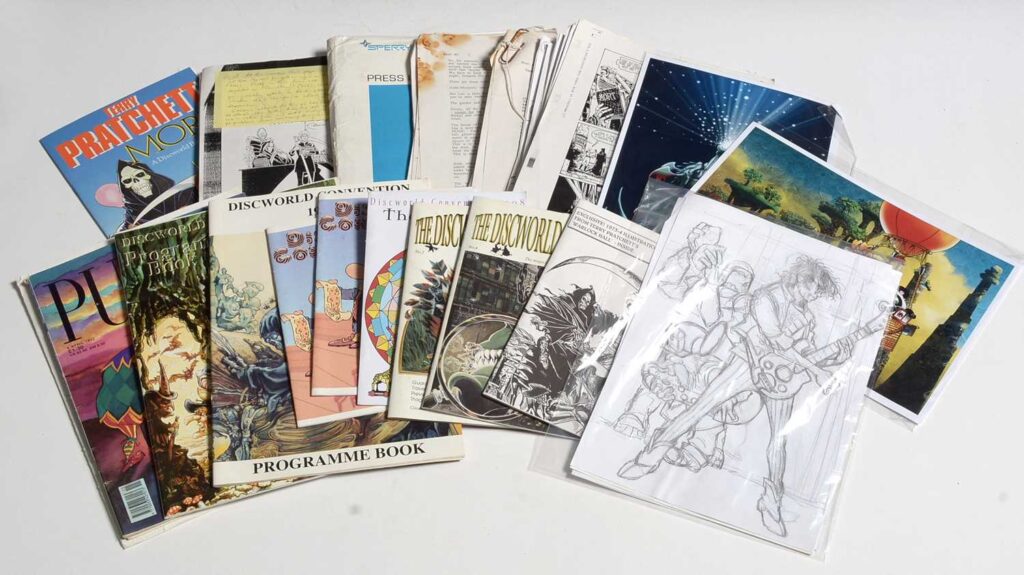 Three pencil drawings and a blue-lined inked-up panel for the Discworld Big Comic, illustrated by Graham Higgins, and published by Gollancz; and publisher's correspondence to the artist, creative notes, and printers' proofs; together with a small quantity of Discworld convention programmes, and Terry Pratchett-related magazines.