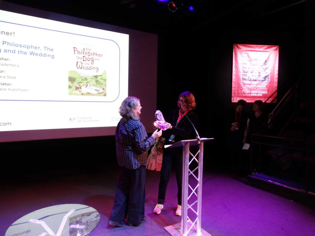 Ivanka Hahnenberger of VIP Brands presents translator Michele Hutchison with the inaugural Sophie Castille Award during this year's Lakes International Comic Art Festival