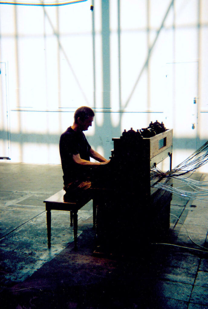 Richard Asford playing piano at an installation by David Byrne New York's Battery Maritime Building in 2008. Photo courtesy Cefn Ridout