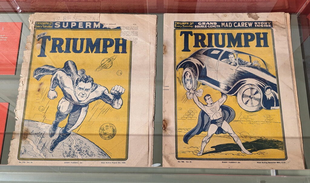 Copies of Triumph featuring reprints of Superman, part of the Cartoon Museum's "Heroes" exhibition (2024)