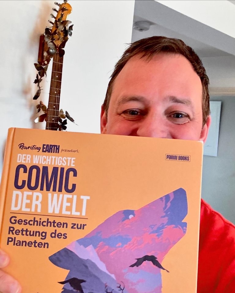 Paul Goodenough with a copy of "The Most Important Comic Book" - published in German, as "Der wichtigste Comic der Welt. Geschichten zur Rettung des Planeten"