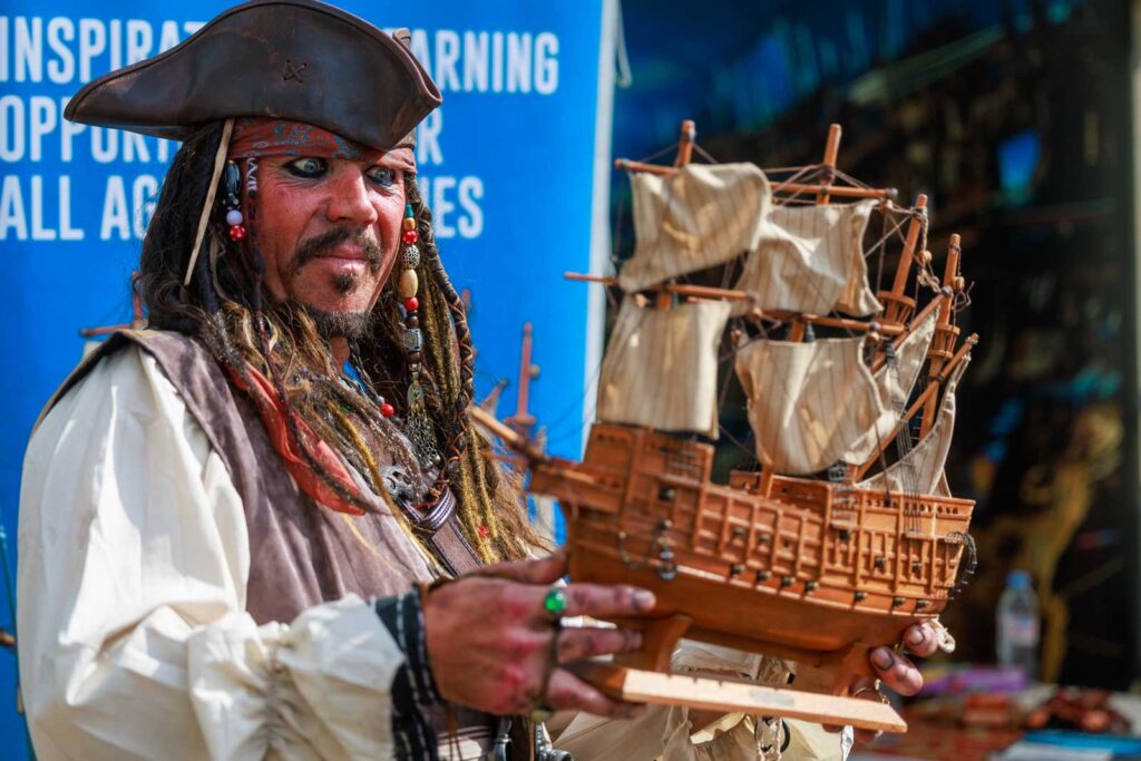 Portsmouth Comic Con 2024 - A curious pirate eyes up a model of Portsmouth's famous Mary Rose - Photo: Steve Spurgin