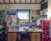Raymond Briggs's desk and the view from his studio across the Weald to the North Downs near Caterham Photo via Ditchling Museum