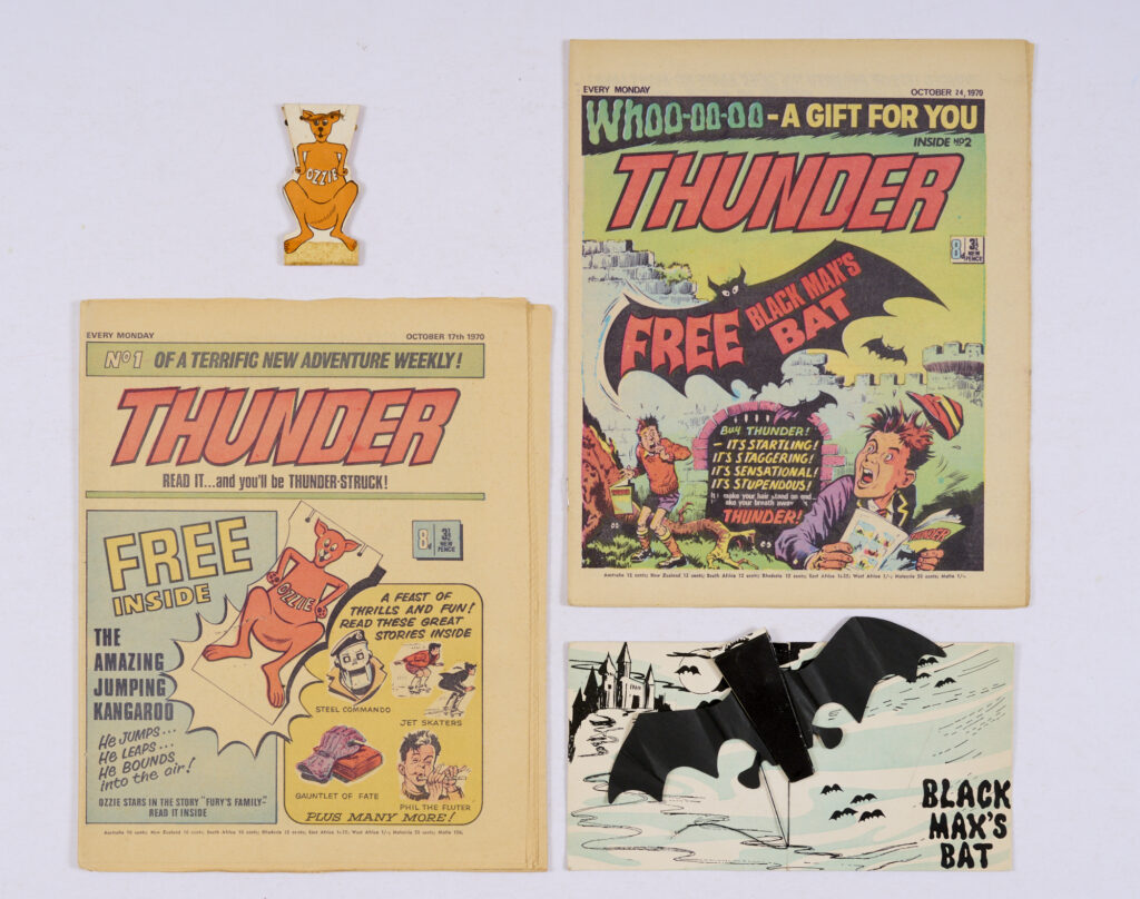 Thunder No. 1 With Free Gift, Ozzie Jumping Kangaroo and No. 2 WFG, Black Max's Bat (one wing with clear tape repair). Starring "Fury's Family" with art by Denis McLoughlin, "Adam Eterno" and "Black Max" by Eric Bradbury. No. 1 [fn], no.2 [vfn] (2)