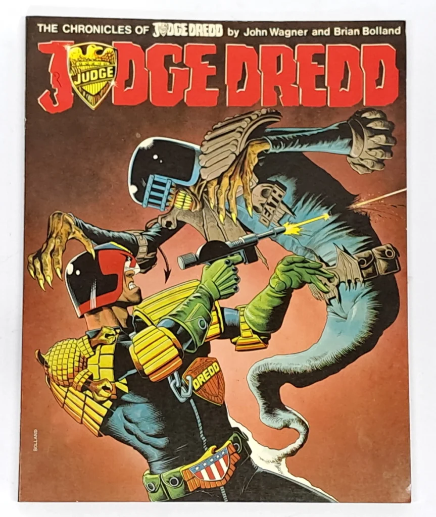 Titans Books “The Chronicles of Judge Dredd” Book Two  Signed inside the front cover by Mike McMahon, Artist, Alan Grant, Writer, Dave Gibbons, Artist & Writer, and Brian Bolland, Cover Artist. Image: Vectis