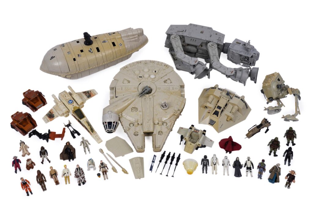 A collection of vintage Star Wars model vehicles and figures, primarily by Kenner Productions, all unboxed, including: a Kenner Productions Millennium Falcon; an AT-AT Walker; a Kenner Productions X-Wing; and others