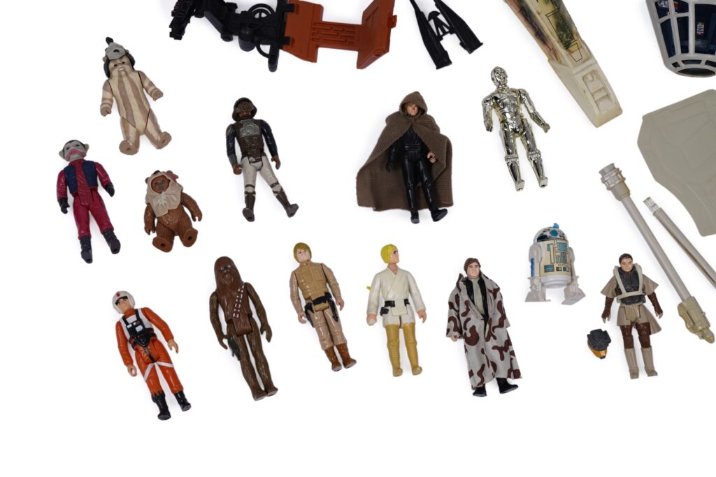 Detail of Anders & Garland Star Wars lot: A collection of vintage Star Wars model vehicles and figures, primarily by Kenner Productions, all unboxed, including: a Kenner Productions Millennium Falcon; an AT-AT Walker; a Kenner Productions X-Wing; and others