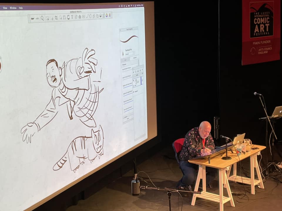 Mike Collins in action, calmly keeping up with ideas from the audience for a Doctor Who story at the 2024 Lakes International Comic Art Festival. Photo: Chris Wright