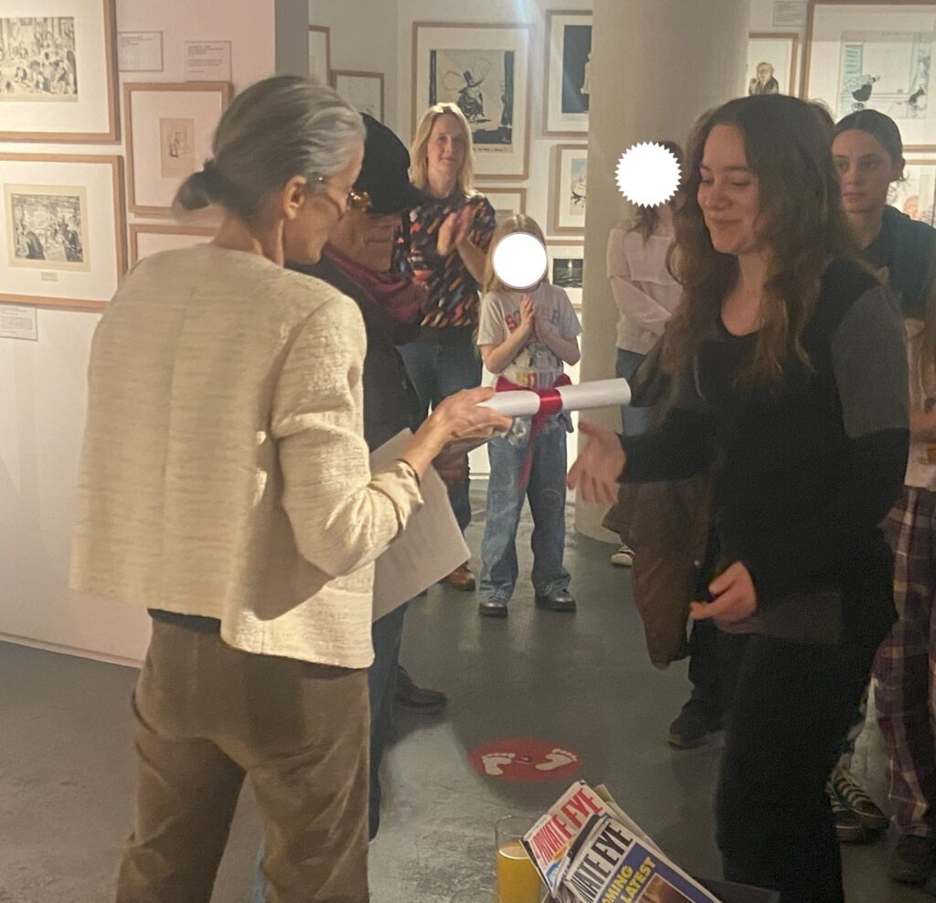 Jess Judge and Ryan Fairbanks accept their Young Cartoonist Awards, handed out by British Cartoonists Association and Cartoon Art Trust chair cartoonist Nicola Jennings. Photo courtesy the Cartoon Museum