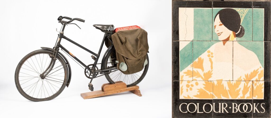 Pictured: A W. H. Smith newspaper delivery bicycle, mid 20th Century, an adapted version of the ‘Model N’ tradesmen’s bicycle by Gundle for W. H. Smith, with pannier bags and W. H. Smith sign to the back, the wheels 23" diameter, label for Gundle, Birmingham. Also, a tiled W. H. Smith advertising sign, depicting a lady and titled 'Colour Books', in original oak frame, 45.5cm x 38cm, with frame 66cm x 59cm