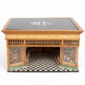 A late 19th Century oak and painted model of a W. H. Smith high street store, an applied label to the side reading ‘This model of a typical W. H. Smith and Son shop is made to the scale of one inch to one foot’, the reverse applied with miniature advertising posters, with a loose brass plaque ‘Presented by W. H. Smith, Esq., M.P., 1873', the WHS logo in painted glass to the top, 67cm wide, 51.5cm deep, 37.5cm high, on a later display stand. Likely designed with the involvement of W. H. Smith in in-house architect Francis Charles Bayliss, F.R.I.B.A. (1876-1938). Between 1905 and 1938 Bayliss was the design coordinator for W.H. Smith & Son and responsible for the design of all shops and retail outlets.