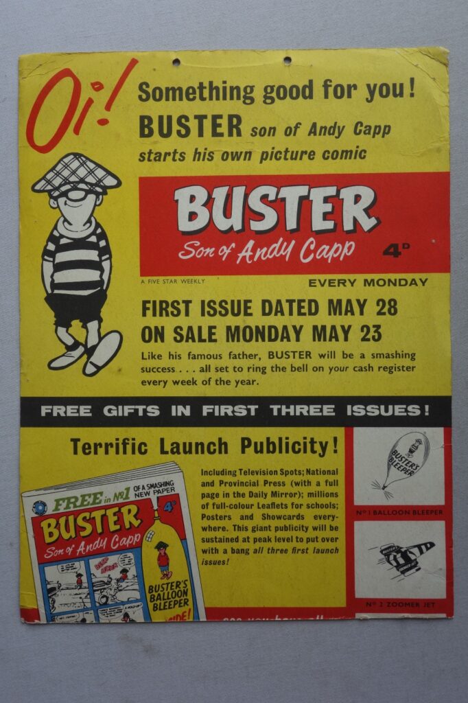 A rare promotional poster clearly identifying Buster as "The Son of Andy Capp", promoting the first three issues of Buster, made from reasonable thick cardboard with two holes (as issued) to the top centre edge, to be strung up and hung in newsagents to promote Fleetway's brand new comic in May 1960. The poster promotes its free gifts. Phil-Comics say they've never seen this poster before "and it's a lovely item, beautifully designed and promoted the launch of Buster and the free gifts in the first two issues. 

"It looks like the bottom section of this poster has been cut off as the text continues at the base and it should also have a white box with a picture of the gift from #3 - Instant Disguise Kit. As we've not seen another we can't confirm that, but looks to be the case. That said, it's still very desirable in its existing form. 

It measures approx 13 x 9.25 inches and is printed on both sides. 