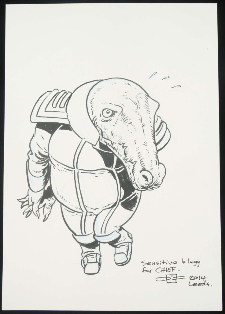 DIsraeli an original artwork of Sensitive Klegg from 2000 AD (2014).
Illustrated work, graphite and inks to card.

Signed by artist to lower margin. Dedicated by artist.

Generally excellent condition.

Original art size approximately: 29.5cm x 20.5cm.
