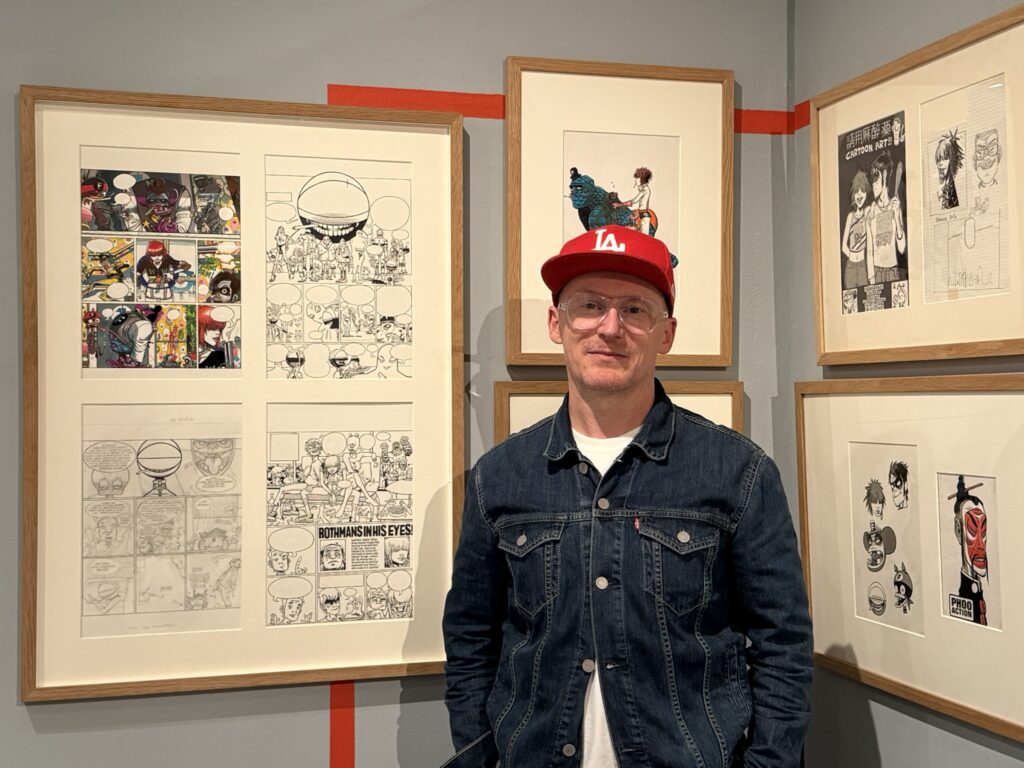 Mat Wakeham talks through the “Phoo Action” corner of the exhibition. Photo: Dean Simons
