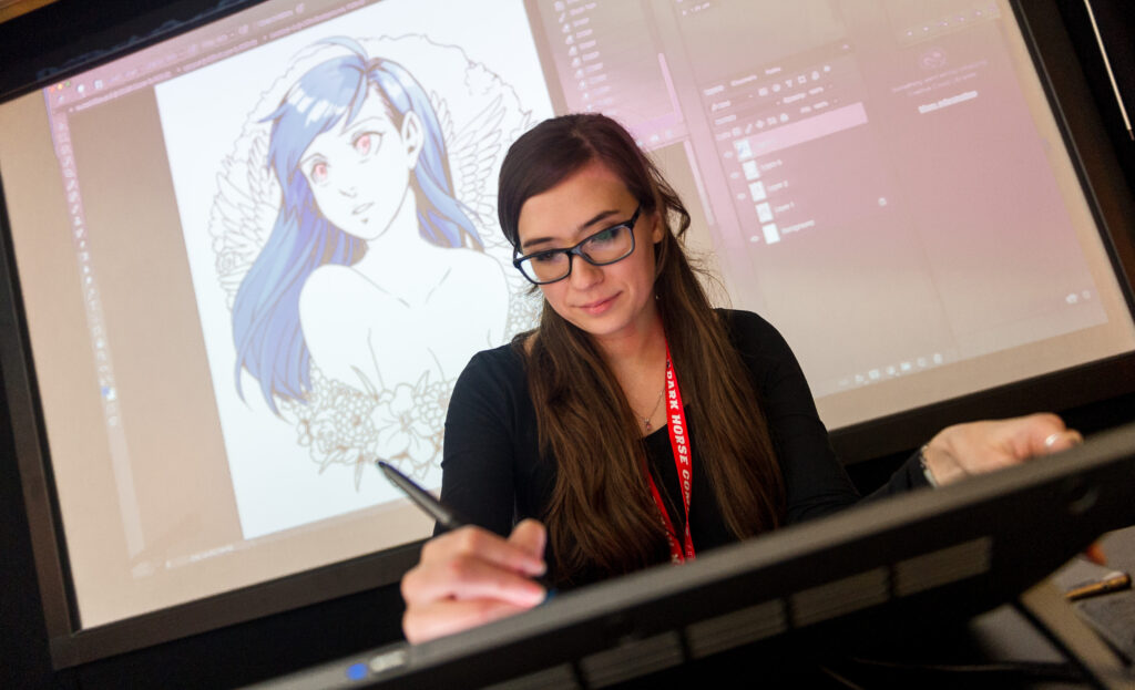 Artist Mikiko draws on the screen at the Brewery's Warehouse cafe during LICAF 2017. Photo: Harry Atkinson